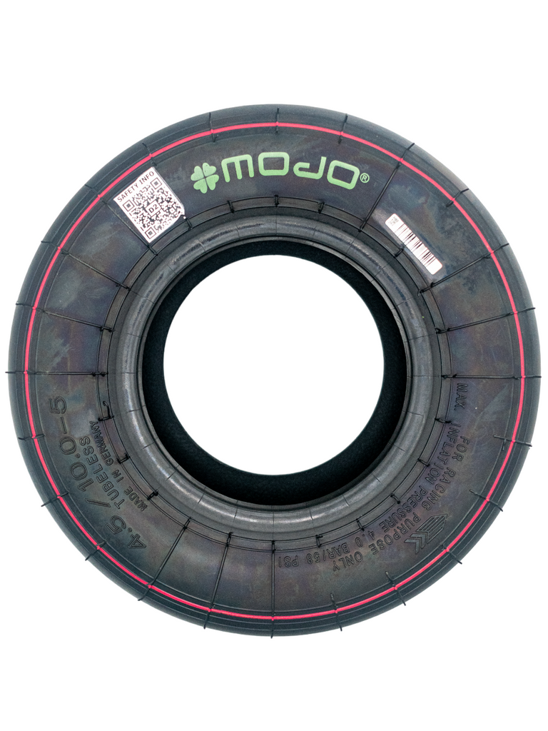 Top Down View of a Mojo D2xx Tire 7.1/10-5. This Tire Serves as the Rear Tires for Junior and Senior Classes Only. There is a Red Ring Around the Tire and a Green Mojo Logo on the Tire Sidewall.