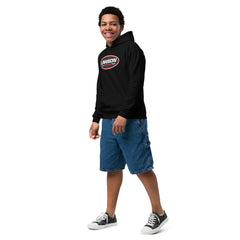 A Smiling Kid Poses Looking Forward Wearing a Black Lawson Speed Shop Youth Heavy Blend Hoodie.